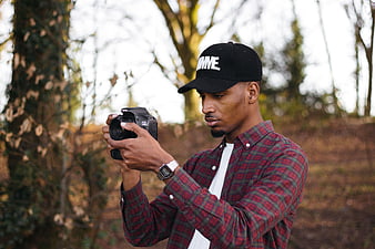 Young Man Photographer Taking Pictures Outdoors