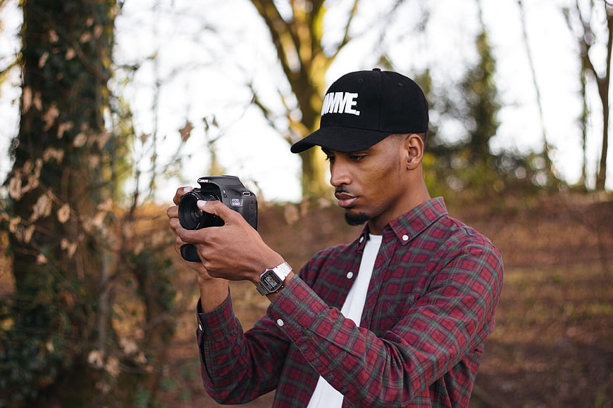Young Man Photographer Taking Pictures Outdoors