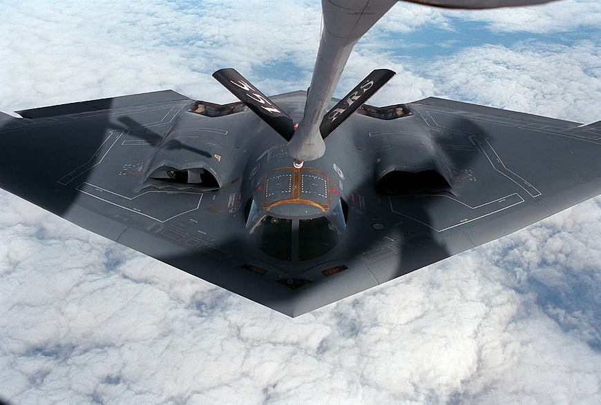 Stealth Bomber Refueling Mid-Air Above Clouds