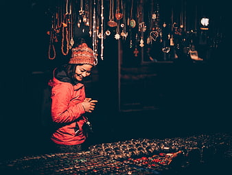 Woman browsing jewelry at a night market stall