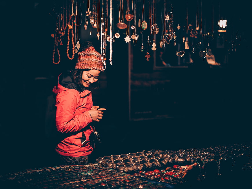 Woman browsing jewelry at a night market stall