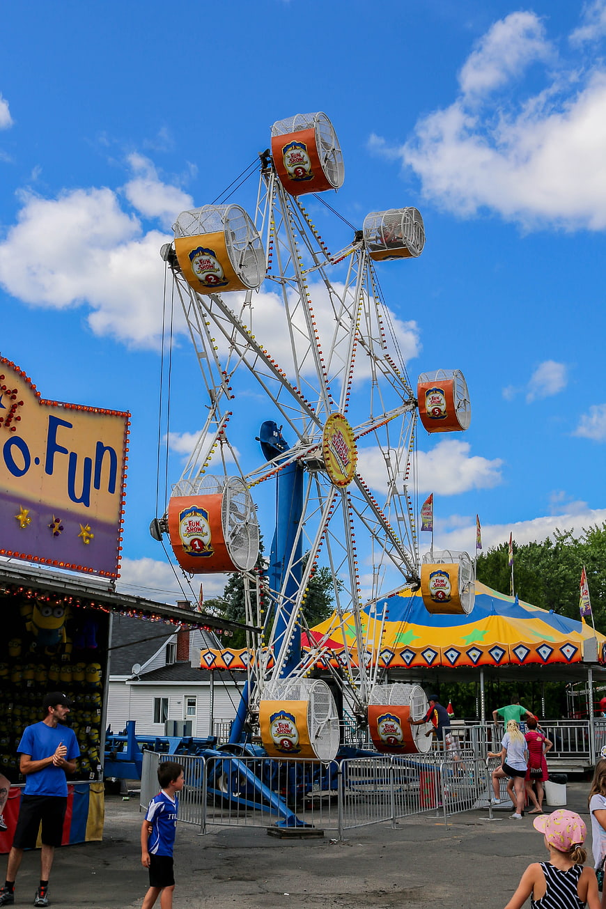 Colorful Ferris Wheel at Summer Fair Under Blue Sky