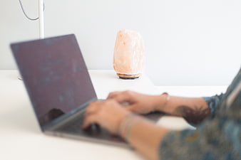 Woman Typing on Laptop with Himalayan Salt Lamp