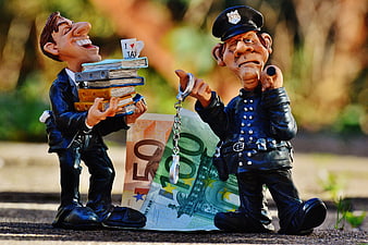 Tax Evasion Concept with Figurines, Handcuffs, and Euro Banknotes