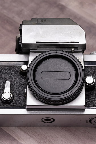 Close-up of vintage Pentax film camera on wooden surface