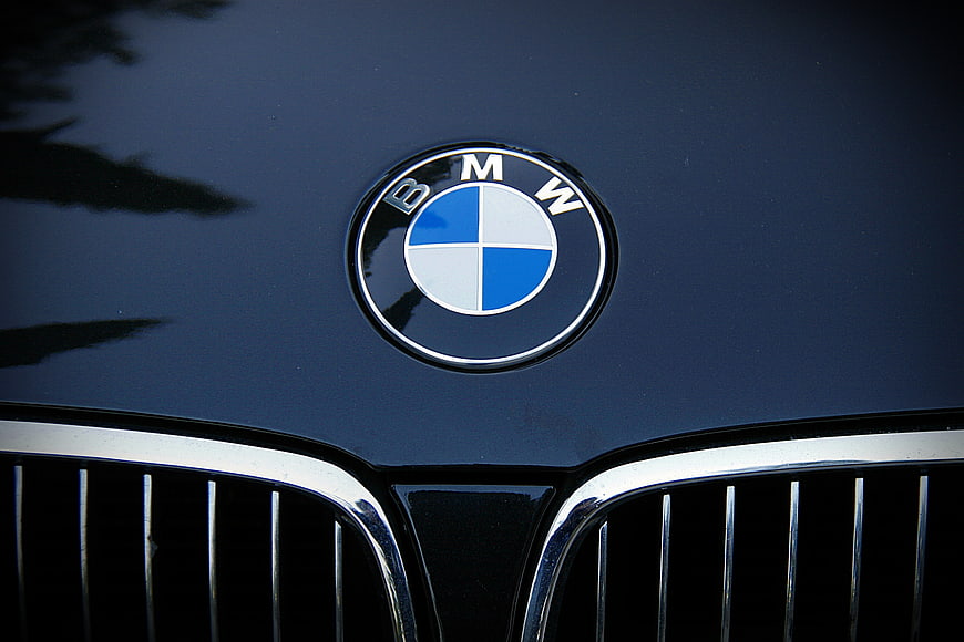 Close-up of BMW emblem on dark blue car hood