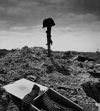 WWII Soldier's Grave with Helmet and Rifle in Normandy