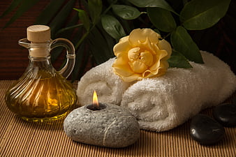 Spa Wellness Still Life With Yellow Rose, Oil, Candle, And Stones