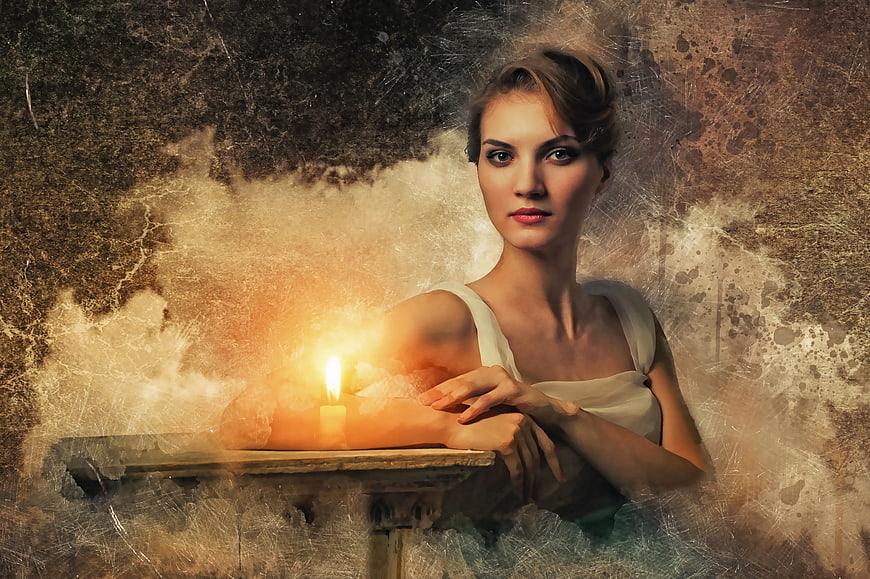 Mysterious woman portrait with candle and vintage grunge texture