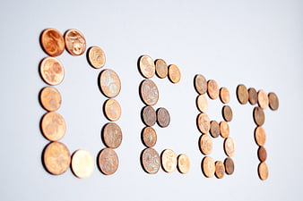 Euro coins spelling out the word debt on white background
