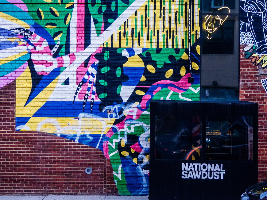 Colorful Abstract Mural on Brick Wall with National Sawdust Sign
