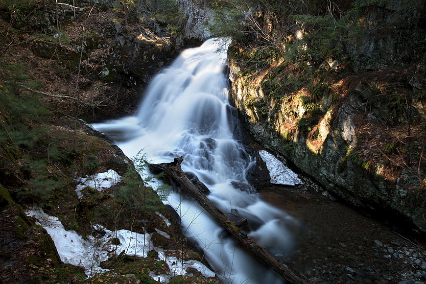 Long Exposure Waterfall in Forest with Snow