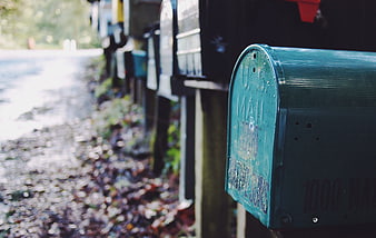 Row of Green Mailboxes on Rural Roadside
