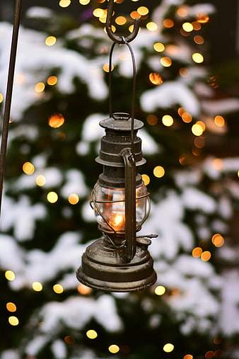 Vintage Lantern Hanging in Snowy Christmas Tree with Bokeh Lights