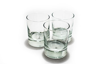 Three Empty Clear Glass Tumblers on White Background