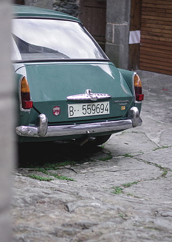Rear view of vintage green Morris 1100 car on cobblestone street
