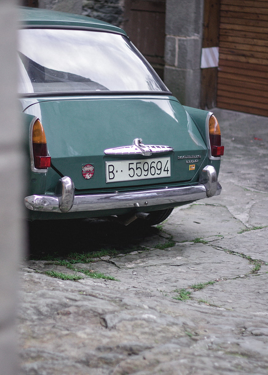 Rear view of vintage green Morris 1100 car on cobblestone street