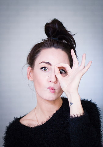 Playful Woman Making OK Sign with Eye
