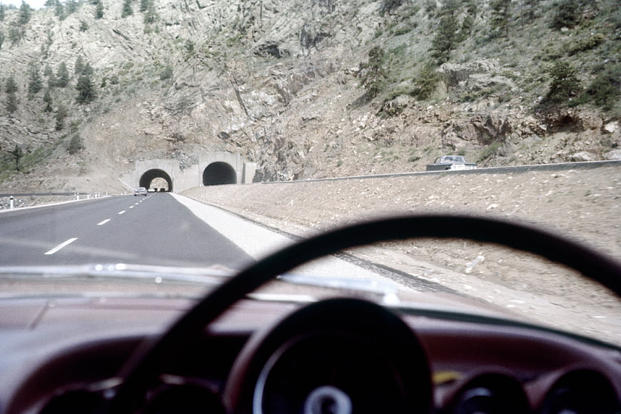 Vintage car dashboard view driving on mountain highway