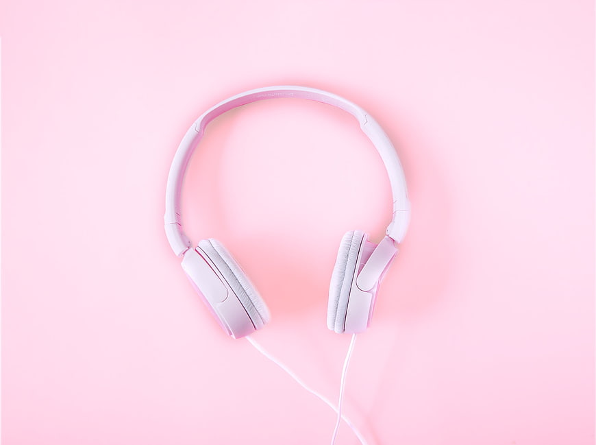 White Headphones on Pink Background