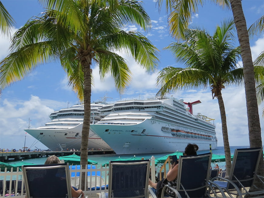 Carnival cruise ships docked in tropical paradise with palm trees