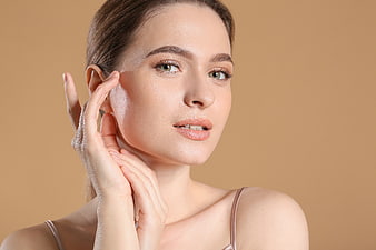 Beautiful Woman Touching Face with Smooth Skin
