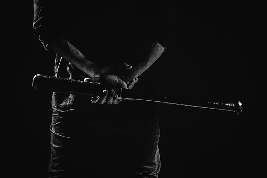Black and white close-up of a baseball player holding a bat