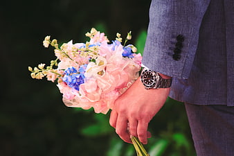 Man in Suit Holding Pink and Blue Flower Bouquet