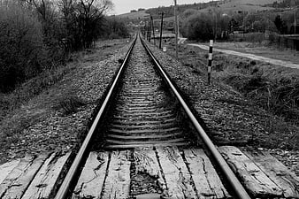 Black and white view of railway tracks stretching into the distance
