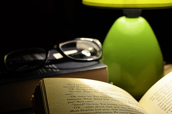 Open Book with Glasses and Green Desk Lamp