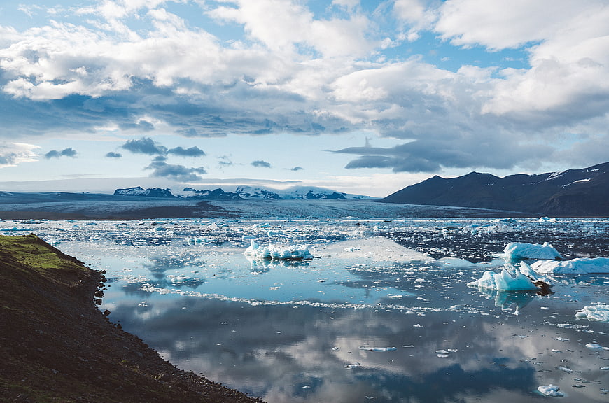 Glacial Lagoon with Icebergs and Mountain Reflections