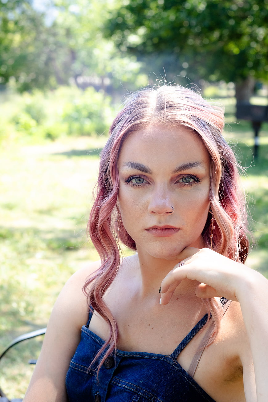 Portrait of woman with pink hair in park
