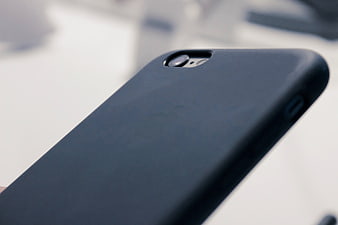 Close-up of black smartphone case on white background