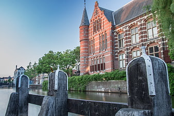 Historic red brick building along canal in Groningen, Netherlands