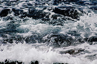 Close-up of turbulent ocean waves with white foam