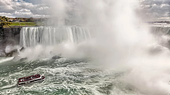 Tour boat navigating misty Niagara Falls river