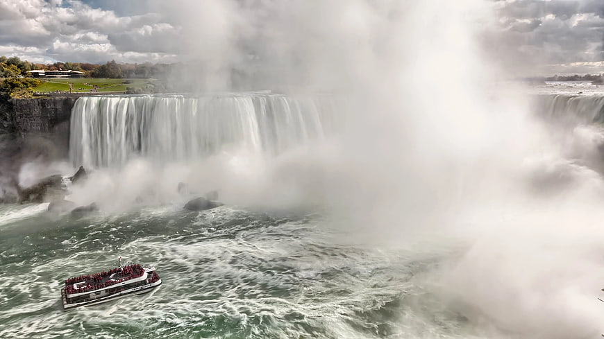Tour boat navigating misty Niagara Falls river