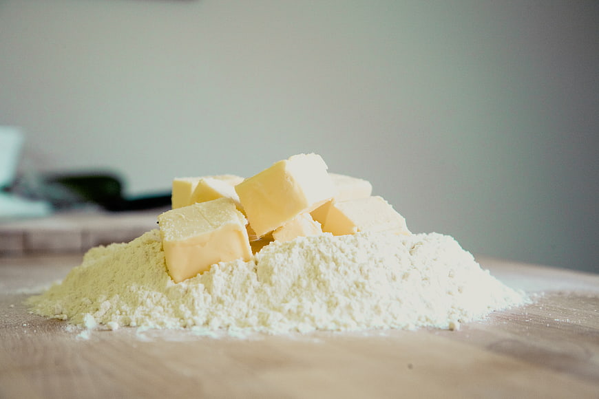 Cubed butter on a pile of flour for baking
