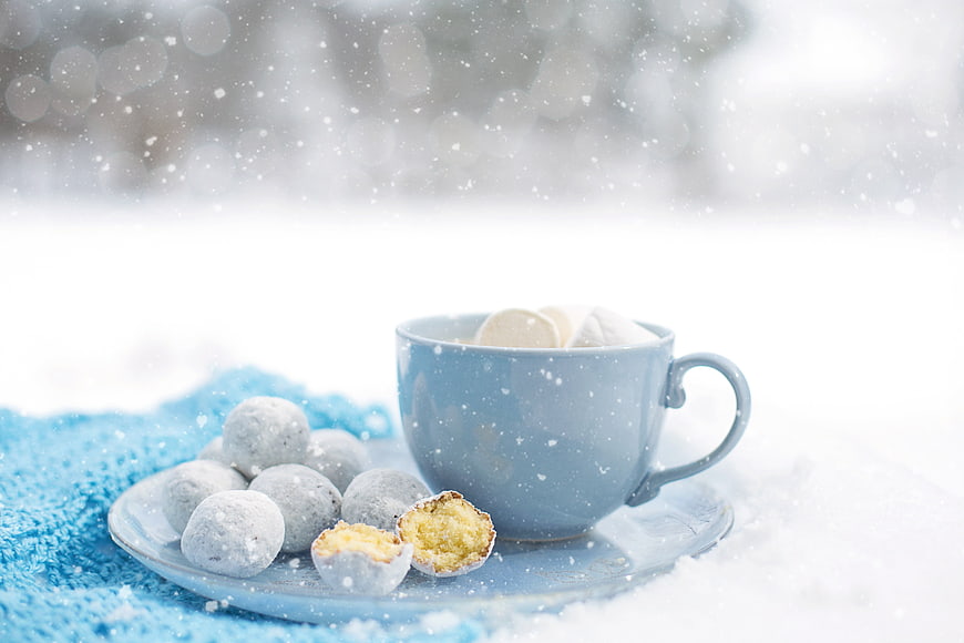 Hot Cocoa and Snowball Cookies in Winter Snow