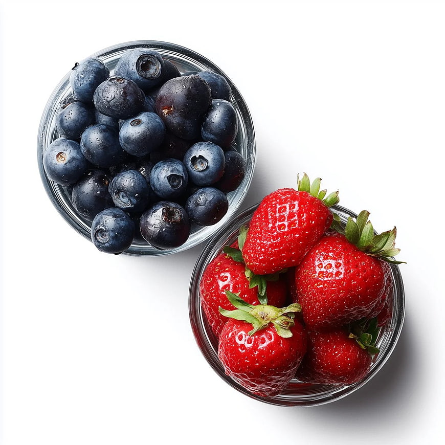 Fresh Blueberries and Strawberries in Glass Bowls on White