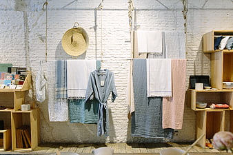 Boho home decor shop interior with linens and wooden shelves