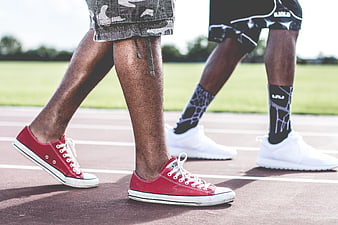 Athletes Walking on Track Wearing Sneakers and Shorts