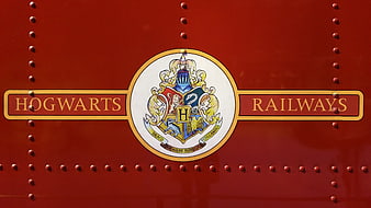 Hogwarts Railways Emblem On Red Riveted Train Exterior