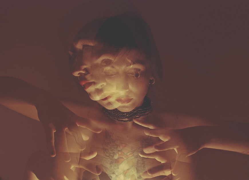 Mystical woman with double exposure face and hands