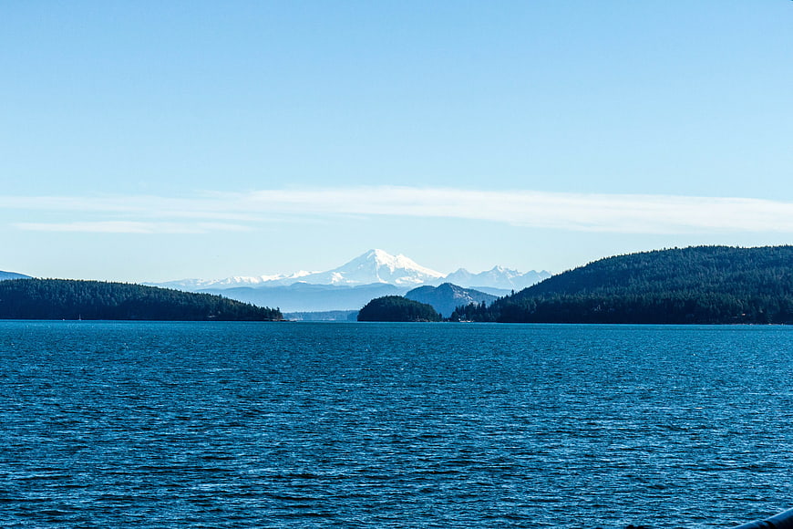 Serene Blue Ocean View with Distant Snow-Capped Mountain