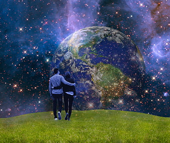 Couple standing on grass hill looking at giant Earth in space