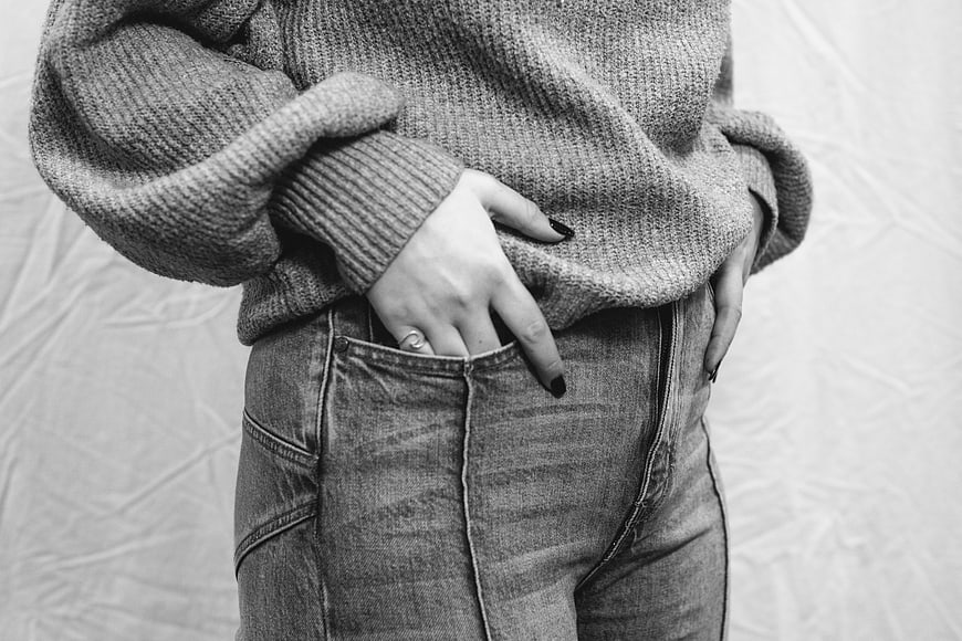 Black and white fashion shot of woman in sweater and jeans