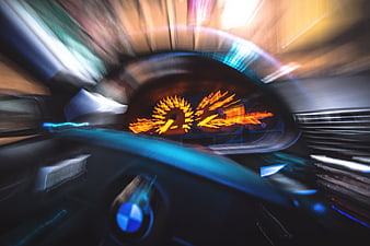 Motion blur view of BMW car dashboard and speedometer