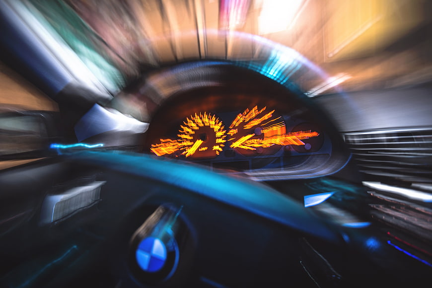 Motion blur view of BMW car dashboard and speedometer