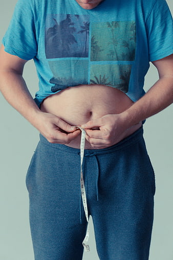 Man Measuring Belly with Tape Measure for Weight Loss